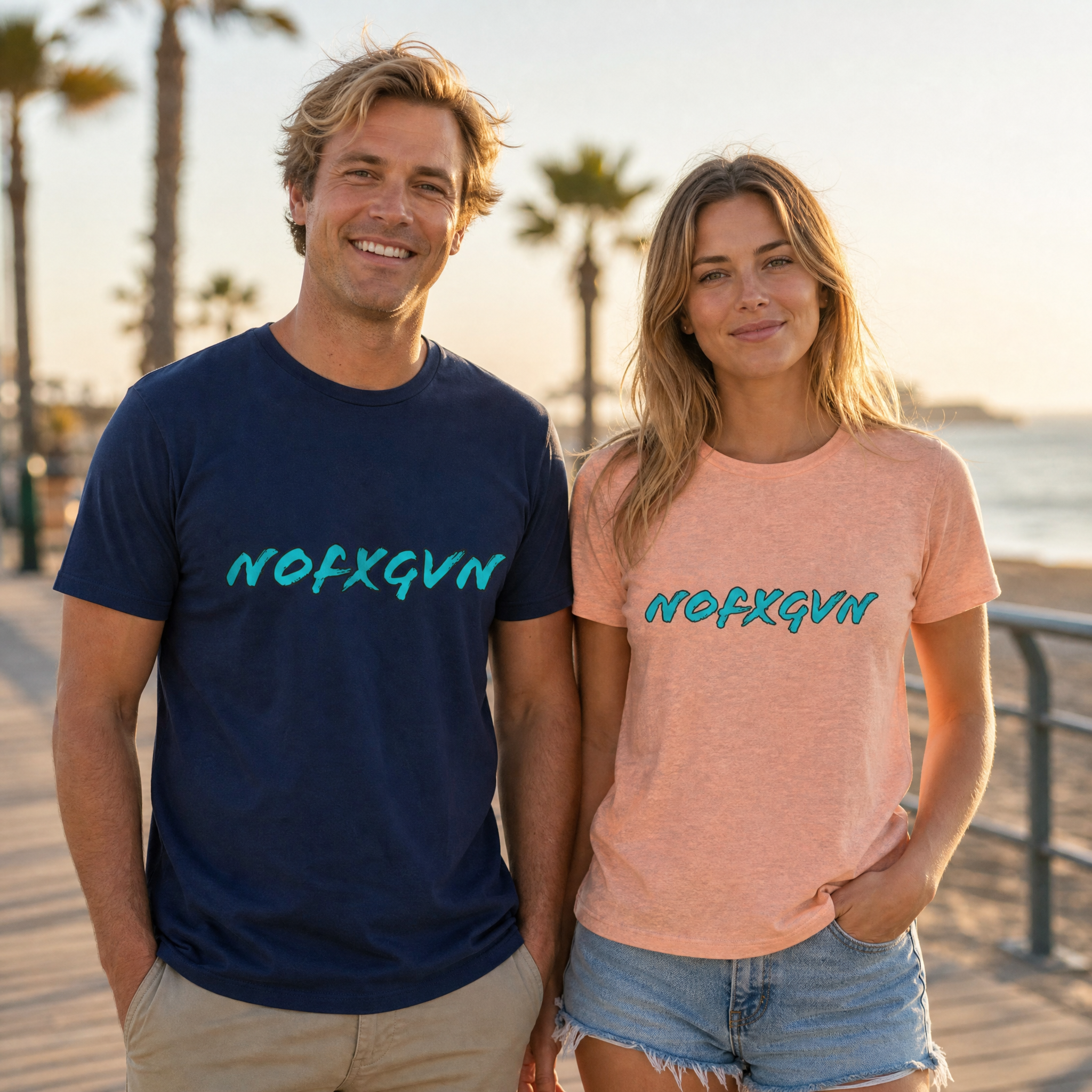 NOFXGVN Retro Aqua Script Unisex Tee worn by a man in Navy and a woman in Heather Peach on a seaside boardwalk | NOFXGVN